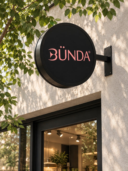 LED projecting blade sign installed above a storefront with BÜNDA logo