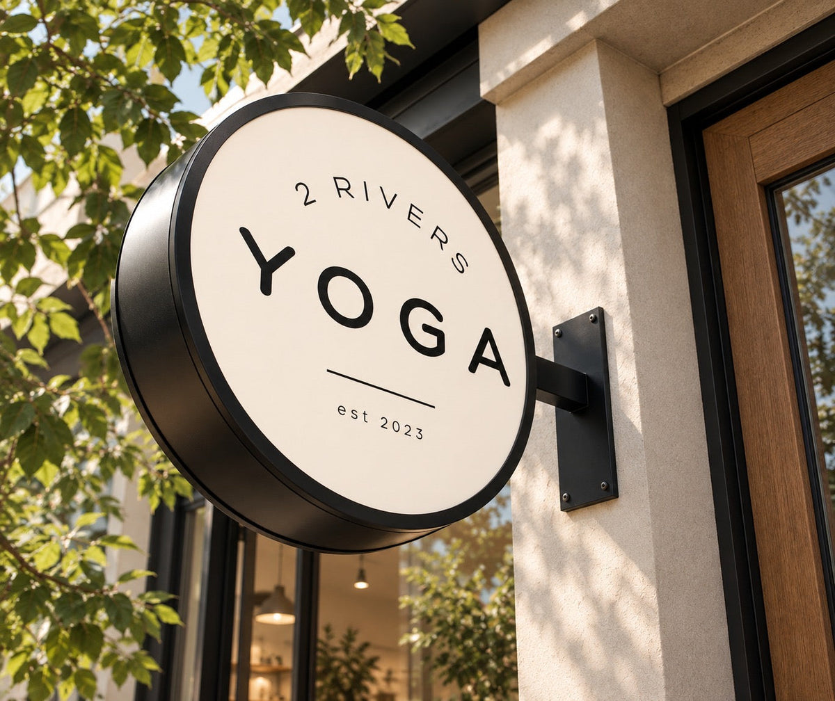 LED projecting blade sign installed at a yoga studio storefront