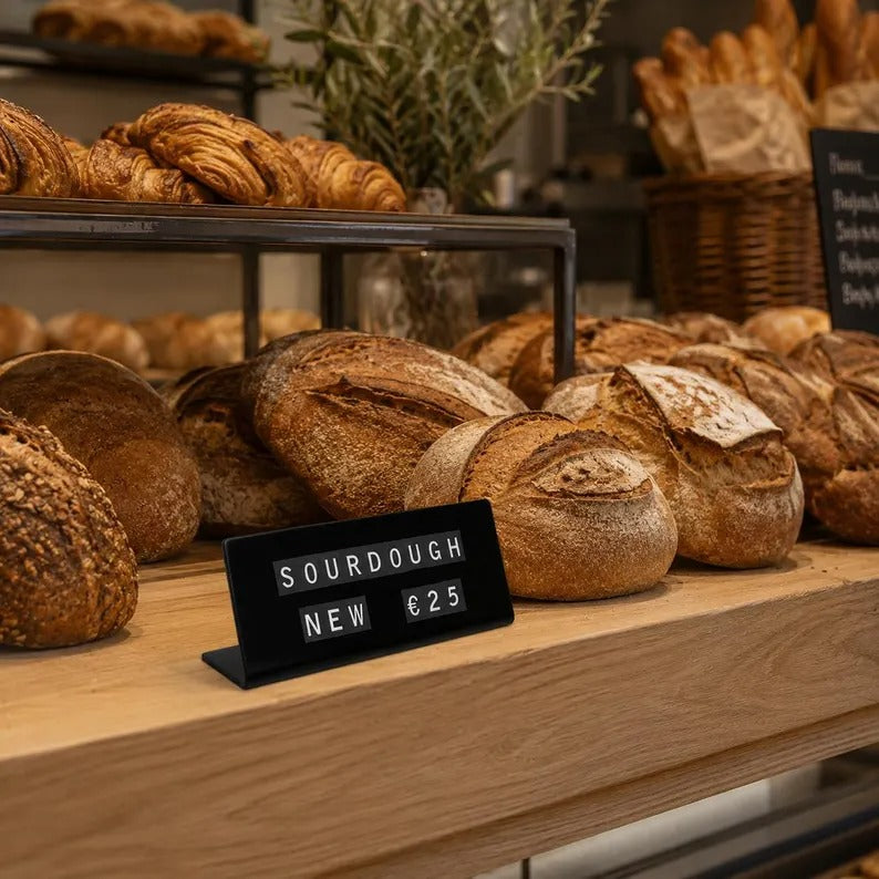 Reusable magnetic price sign with changeable letters in a bakery
