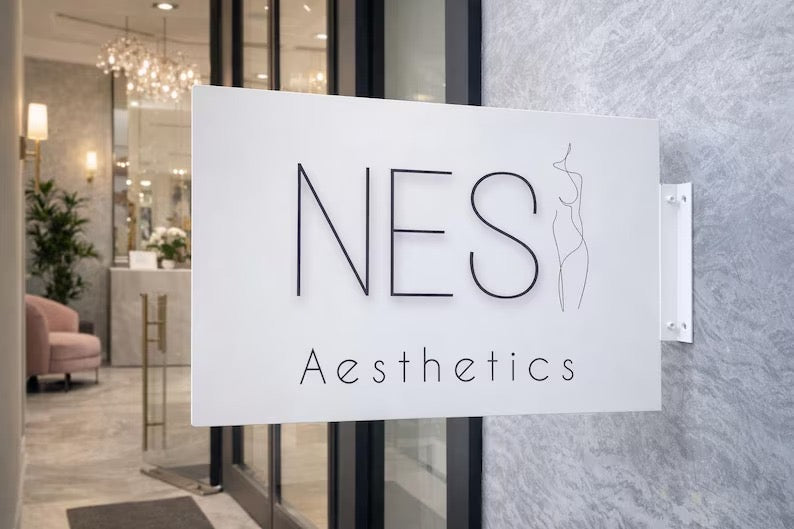 White custom rectangular blade sign for an aesthetics studio